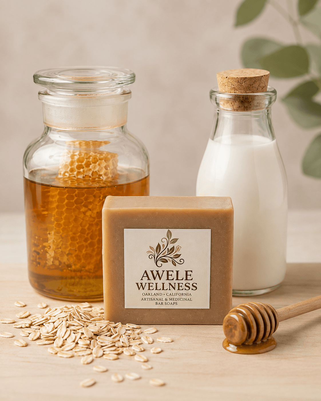 A bar of Awele Wellness Oat & Honey soap surrounded by honey, milk, and oats